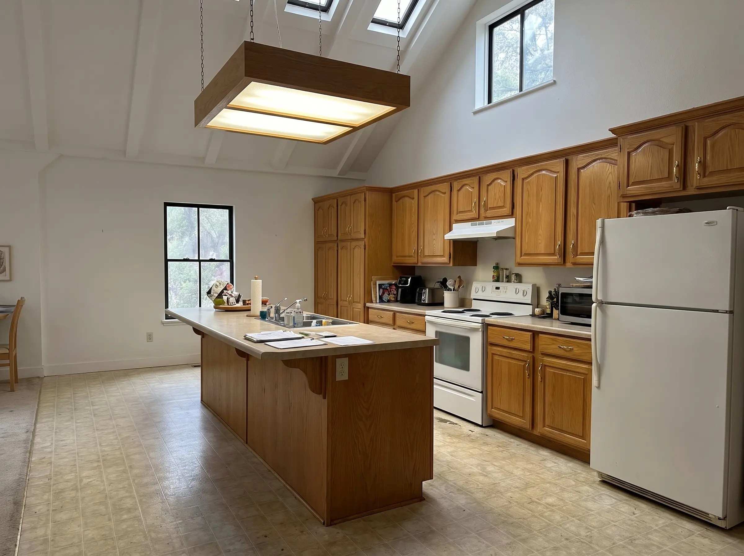 Maplehurst kitchen before renovation: dated oak cabinets and laminate counters